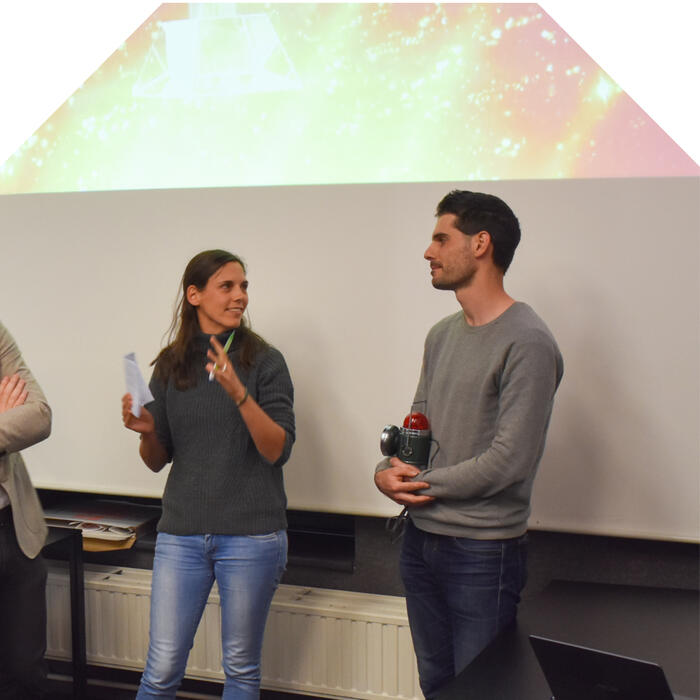 Guillaume receiving the first prize from Lena Weissert ‏from University of Auckland