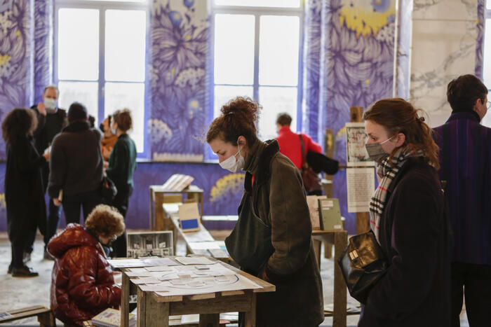 People inspecting the copy-paste participation exhibition in the Pandora Room of SeeU